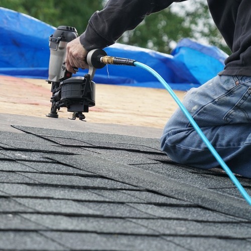 A roofer makes roof repairs.