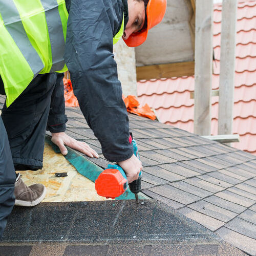 Roofer works on a roof repair.