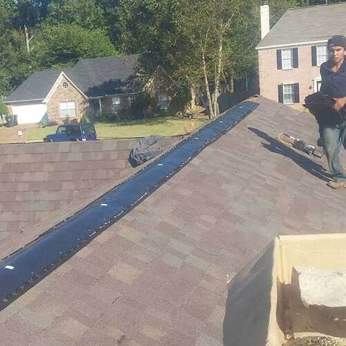 Roofers at work on a roof replacement.